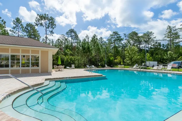 a view of swimming pool with seating space