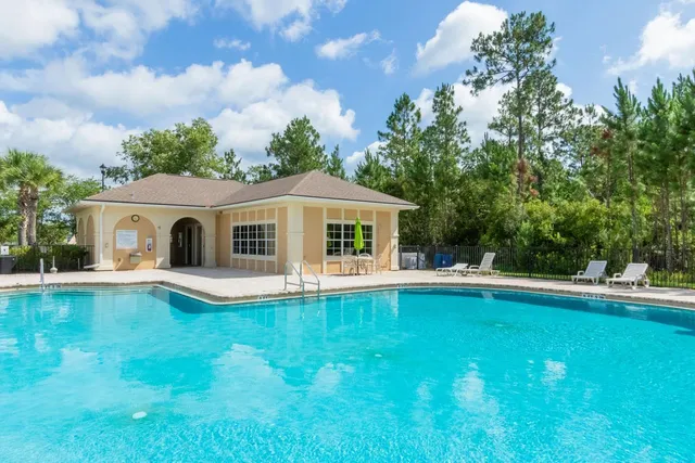a front view of house with yard and swimming pool