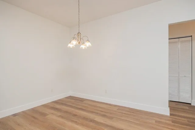 a view of a room with wooden floor and white walls
