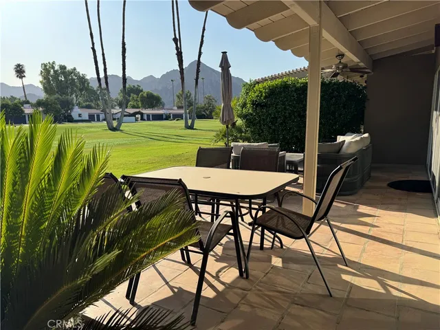 a view of a patio with table and chairs and potted plants