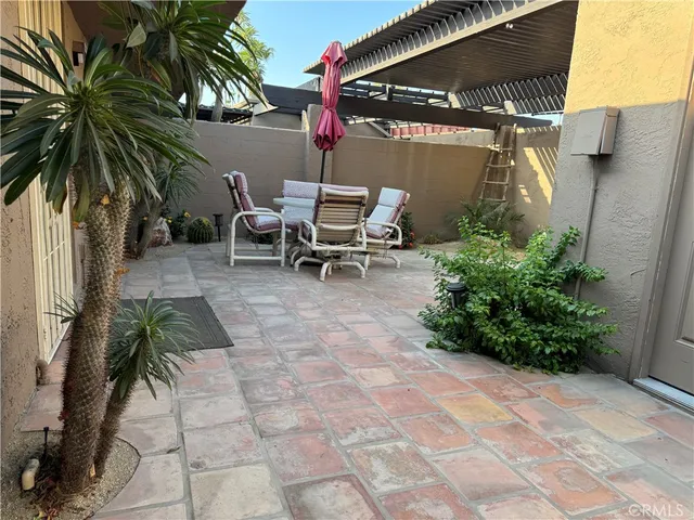 an aerial view of a city with lots of residential buildings and mountain view in back