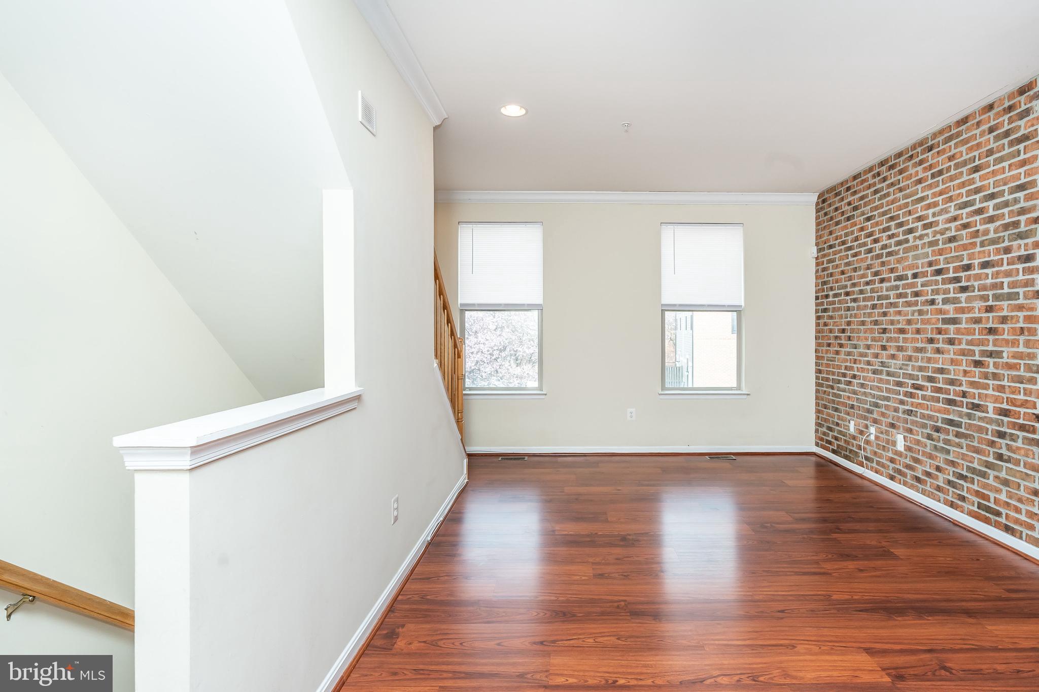 8 South Exeter Street, Unit 142 Baltimore, MD 21202 - Photo 12 of 43 Living Room w/ Brick Wall