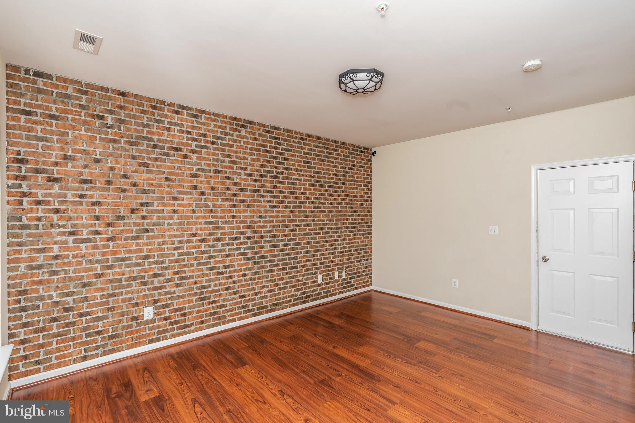 8 South Exeter Street, Unit 142 Baltimore, MD 21202 - Photo 7 of 43 Brick Wall & Laminate Floors
