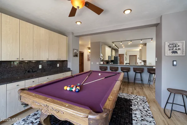 a spacious bedroom with a bed and a flat screen tv