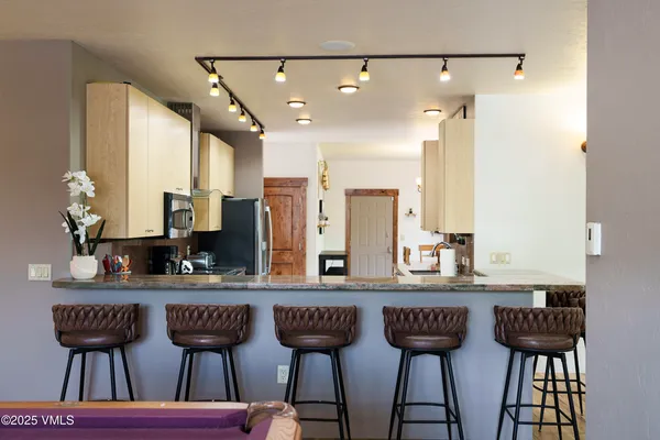 a bathroom with a sink a toilet a mirror and shower