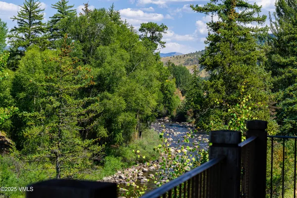 a bathroom with a granite countertop sink a mirror and shower