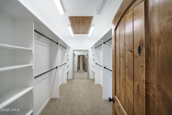 a large kitchen with a sink and stainless steel appliances