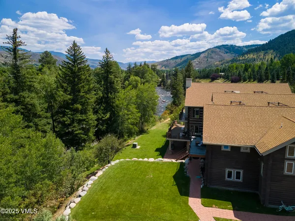 a kitchen with stainless steel appliances kitchen island granite countertop a dining table chairs and granite counter tops