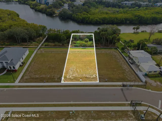 an aerial view of a house with a swimming pool and mountains