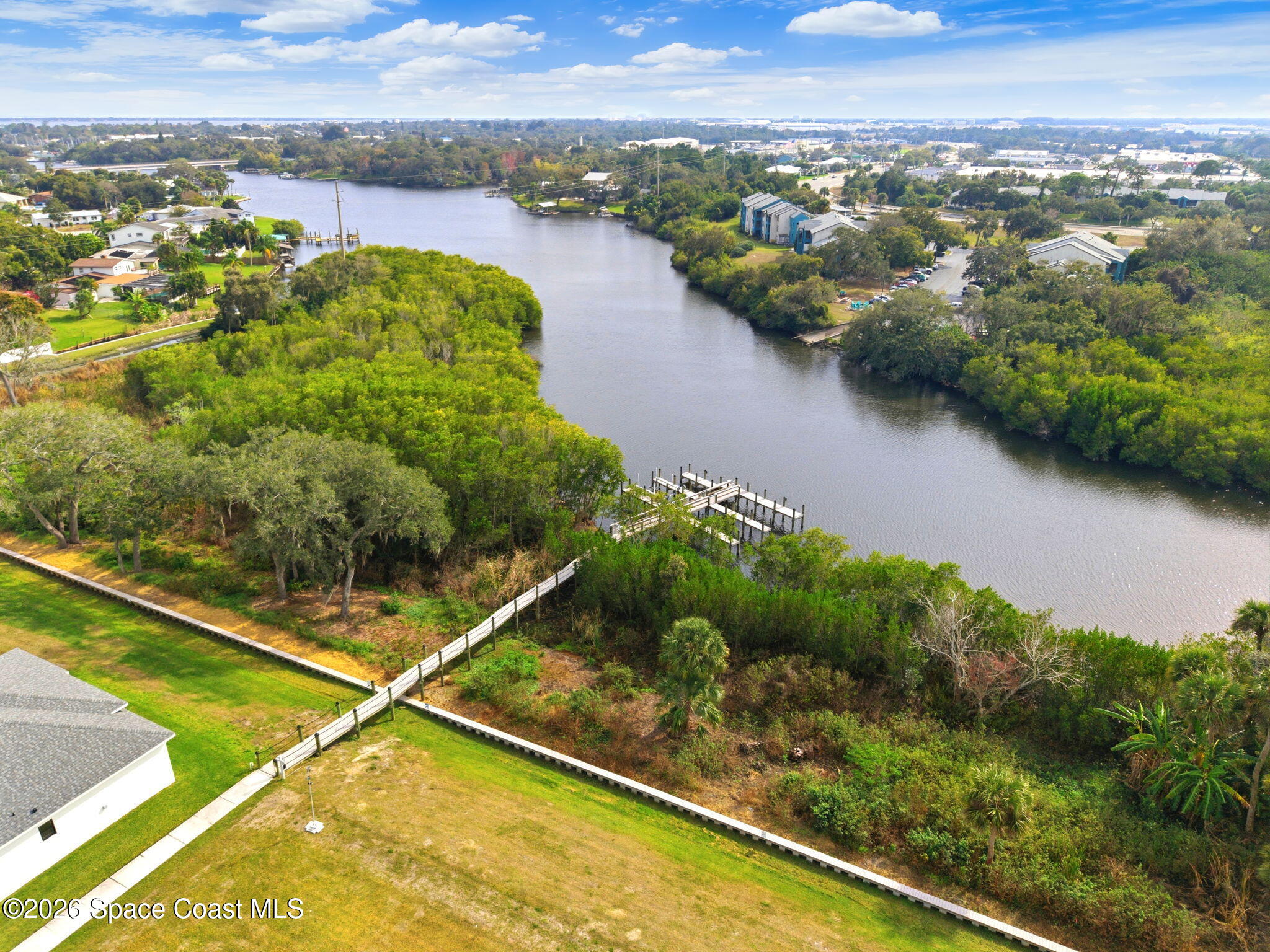 1465 Windchime Lane Melbourne, FL 32935 - Photo 6 of 17 a view of a pool with a garden