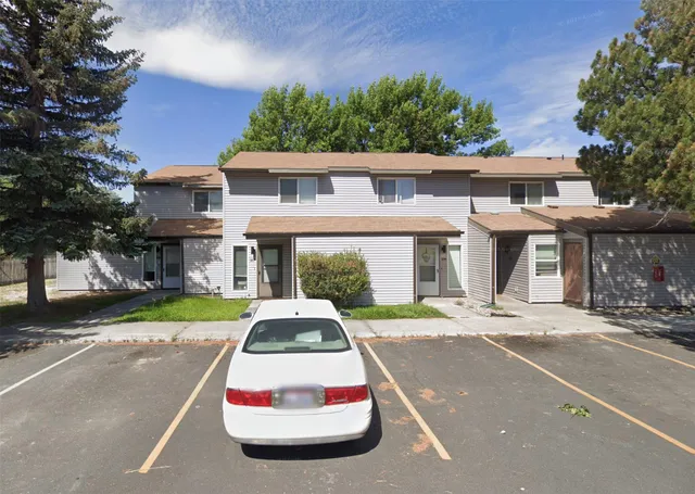 a front view of a house with a yard and seating area