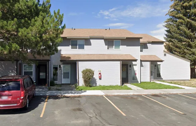 a front view of a house with a garden and garage