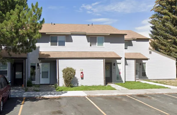 a front view of a house with a yard and a garage