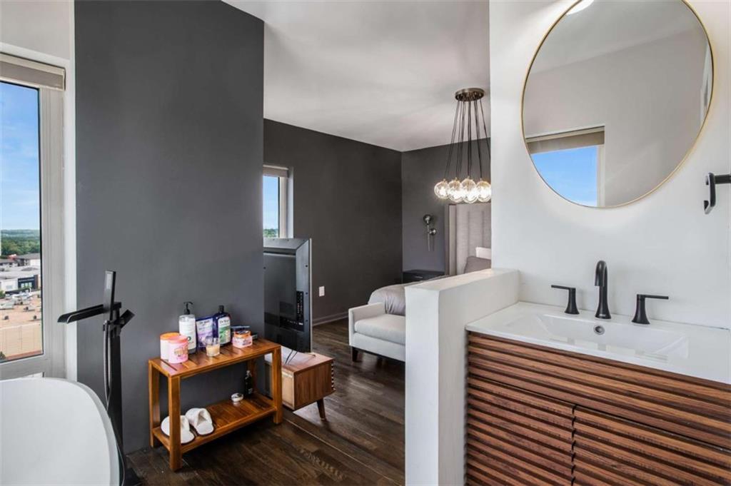 3475 Oak Valley Road Northeast, Unit 1630 Atlanta, GA 30326 - Photo 32 of 38 a bathroom with a sink mirror and vanity