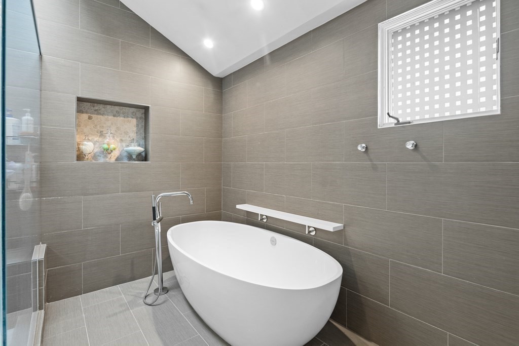 106 Windsor Road Needham, MA 02492 - Photo 15 of 37 a white bath tub sitting in a bathroom