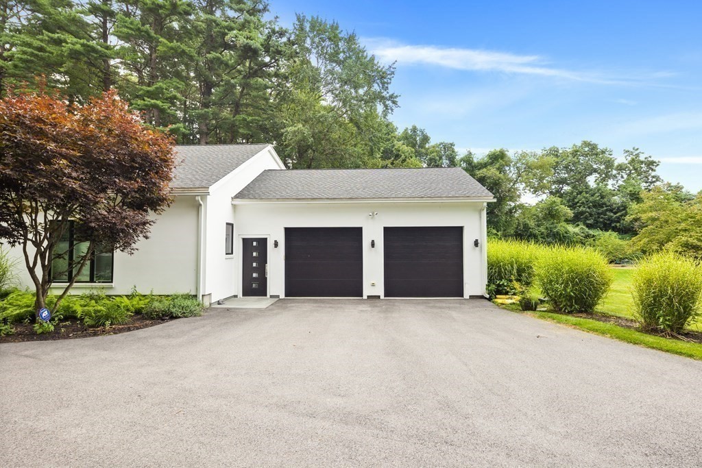 106 Windsor Road Needham, MA 02492 - Photo 2 of 37 a front view of a house with yard and trees