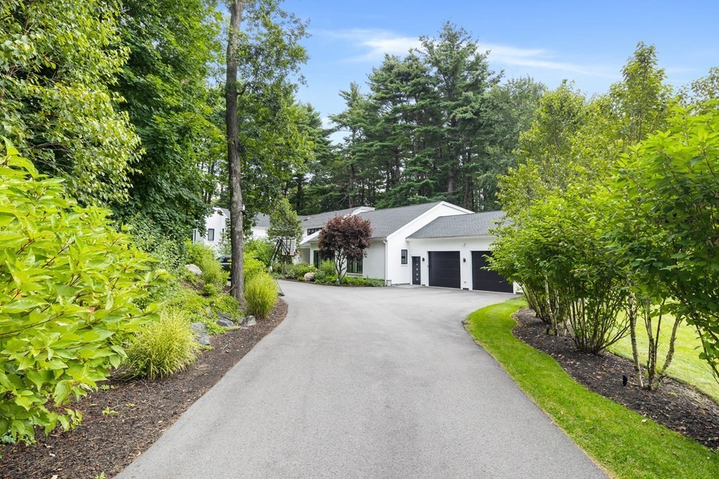 106 Windsor Road Needham, MA 02492 - Photo 23 of 37 a front view of a house with a yard and trees