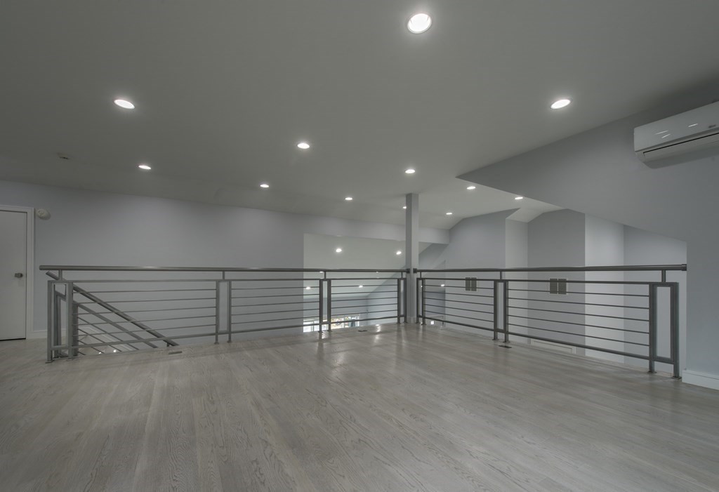 106 Windsor Road Needham, MA 02492 - Photo 27 of 37 an empty room with wooden floor and lots of white walls