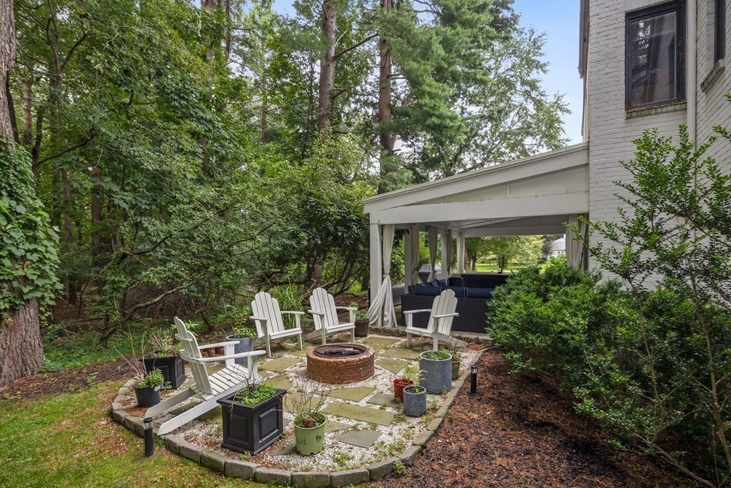 106 Windsor Road Needham, MA 02492 - Photo 28 of 37 a view of a house with backyard fountain and sitting area