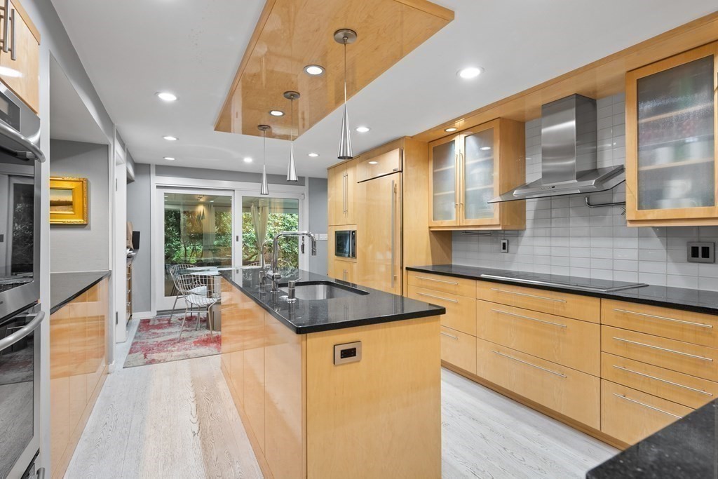 106 Windsor Road Needham, MA 02492 - Photo 3 of 37 a kitchen with stainless steel appliances granite countertop a sink and a large window