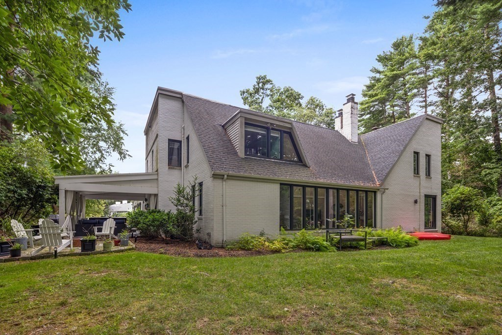 106 Windsor Road Needham, MA 02492 - Photo 33 of 37 a front view of a house with a garden and porch