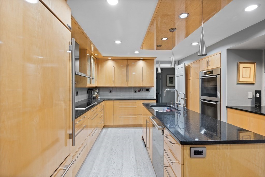 106 Windsor Road Needham, MA 02492 - Photo 4 of 37 a kitchen with counter top space a sink and stainless steel appliances