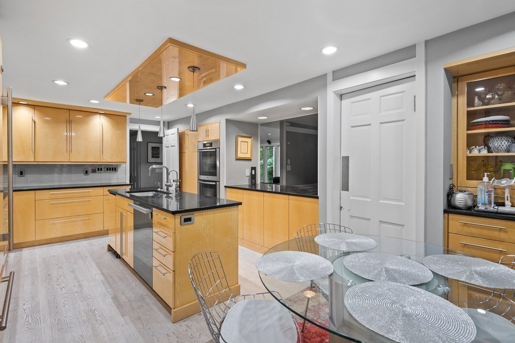 106 Windsor Road Needham, MA 02492 - Photo 5 of 37 a large kitchen with kitchen island a large counter space and stainless steel appliances