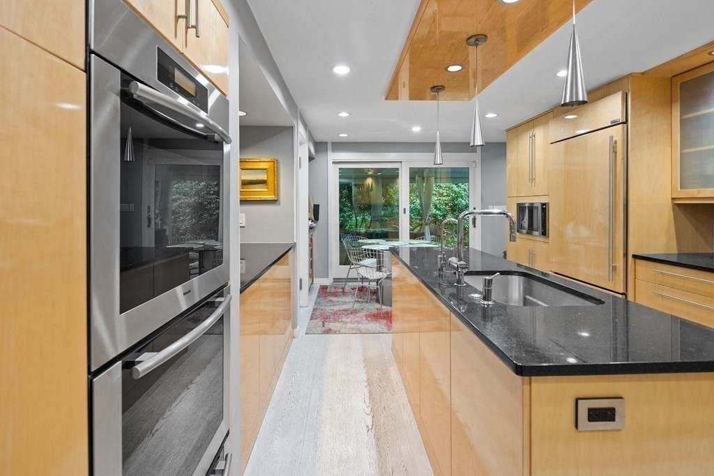 106 Windsor Road Needham, MA 02492 - Photo 6 of 37 a kitchen with granite countertop a sink and a refrigerator