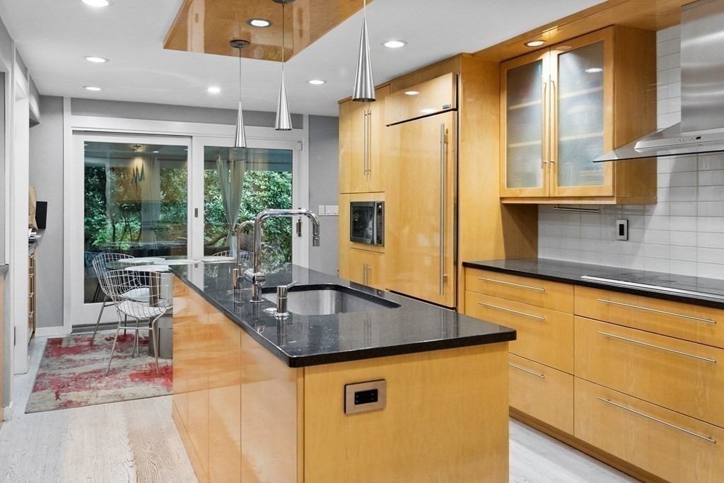 106 Windsor Road Needham, MA 02492 - Photo 7 of 37 a kitchen with stainless steel appliances granite countertop a sink and a refrigerator