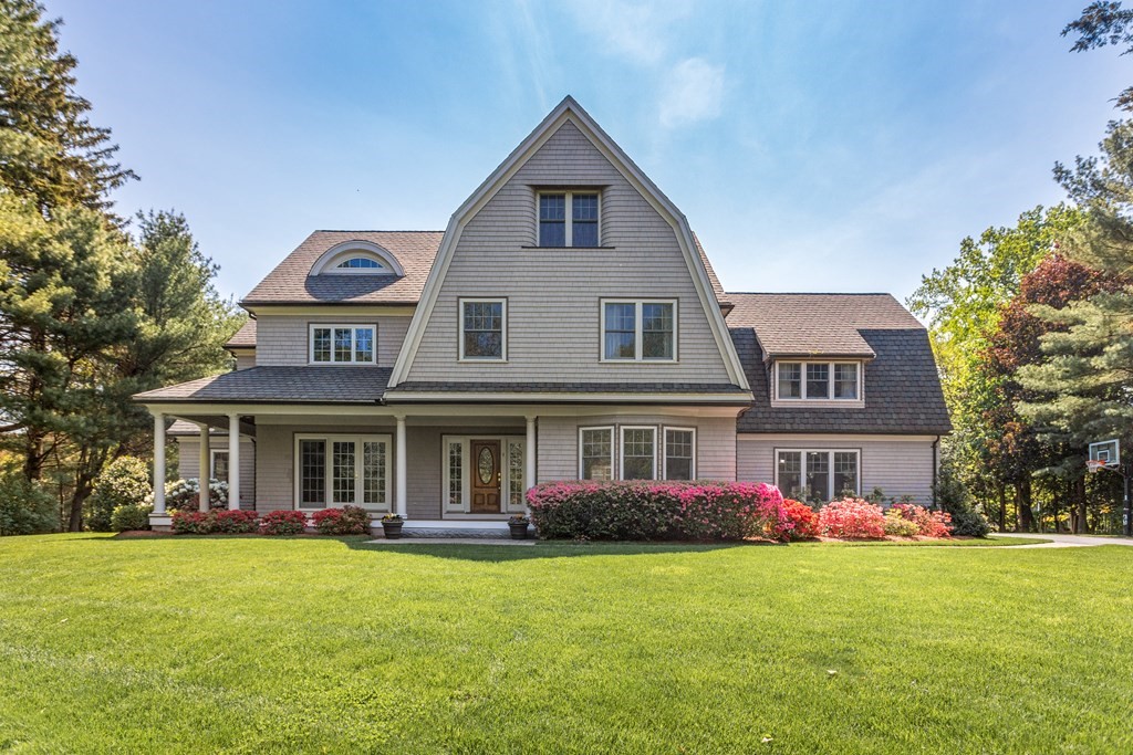 a front view of the house with yard and green space