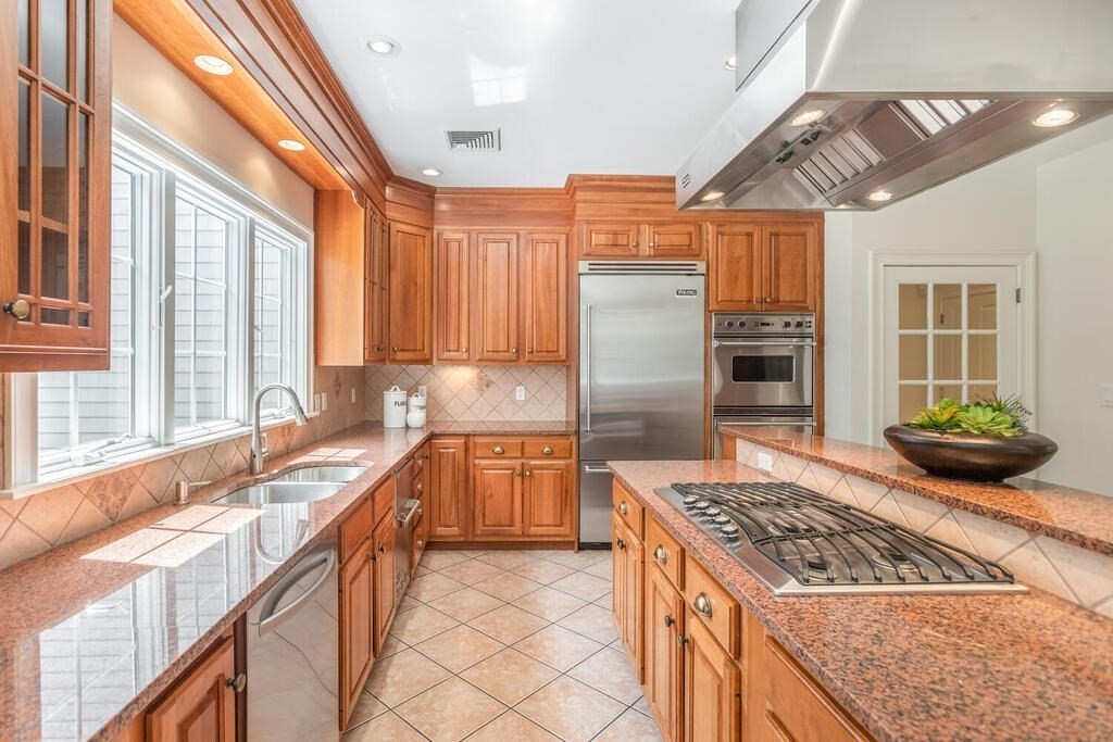 4 Hampton Road Lexington, MA 02421 - Photo 11 of 30 a kitchen with stainless steel appliances granite countertop a stove a refrigerator and a sink