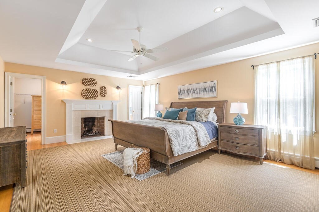 4 Hampton Road Lexington, MA 02421 - Photo 16 of 30 a spacious bedroom with a bed and a fireplace