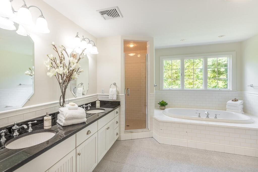 4 Hampton Road Lexington, MA 02421 - Photo 18 of 30 a spacious bathroom with a granite countertop tub a double vanity sink and a window