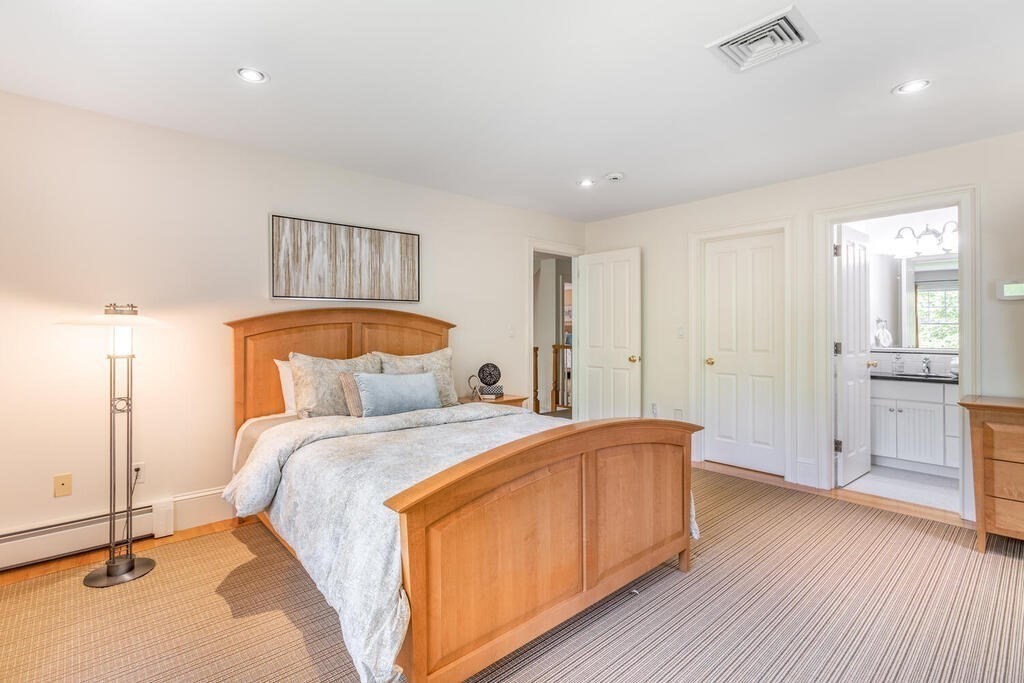 4 Hampton Road Lexington, MA 02421 - Photo 19 of 30 a bedroom with a bed and a chandelier