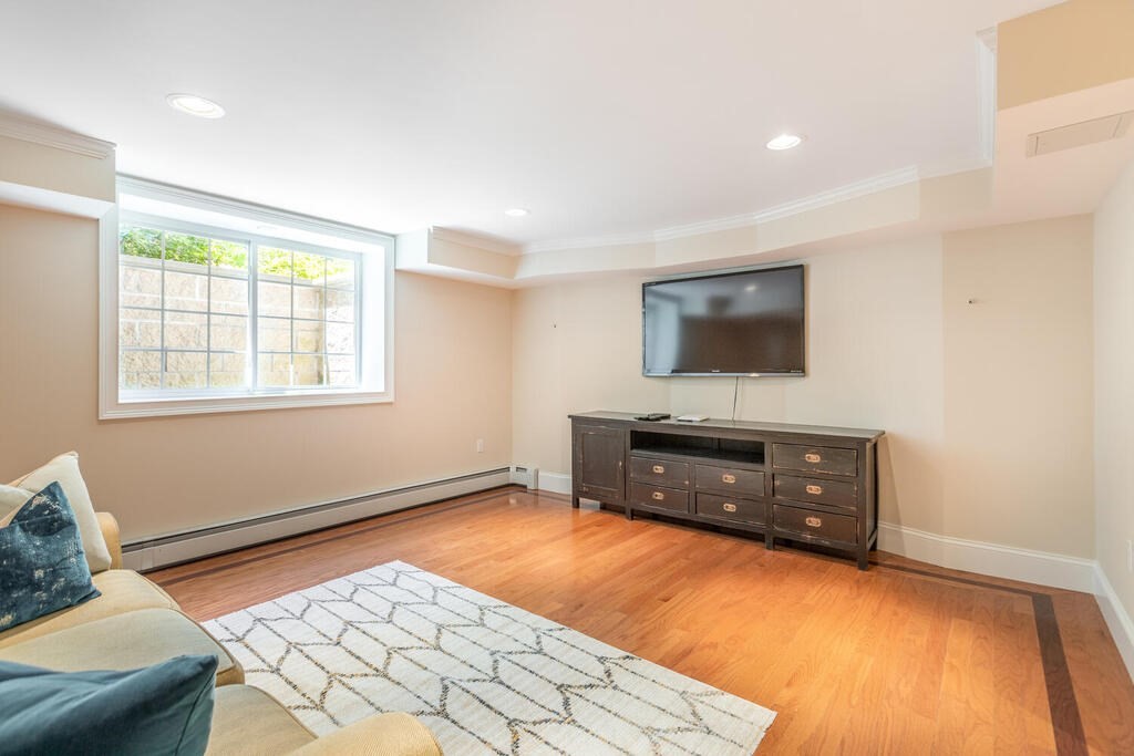 4 Hampton Road Lexington, MA 02421 - Photo 26 of 30 a living room with a flat screen tv and a couch
