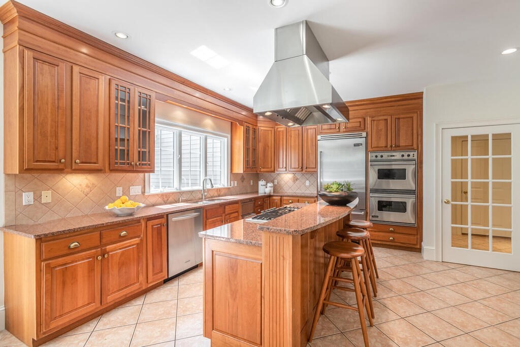 4 Hampton Road Lexington, MA 02421 - Photo 9 of 30 a kitchen with stainless steel appliances granite countertop a stove a sink and a refrigerator