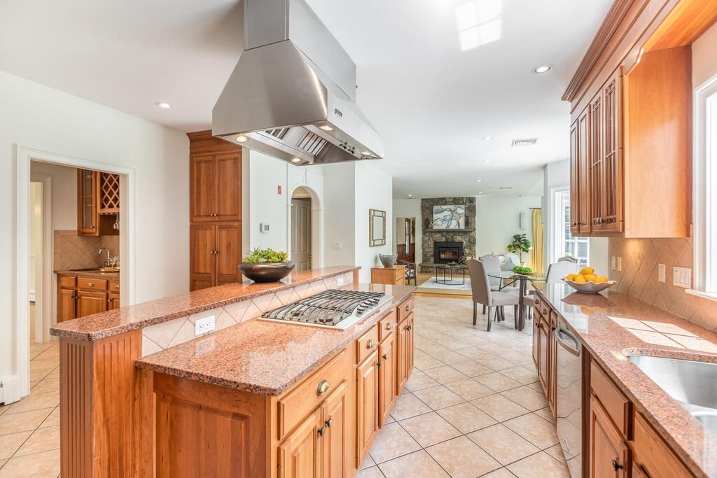4 Hampton Road Lexington, MA 02421 - Photo 10 of 30 a kitchen with a stove a sink a dining table and chairs