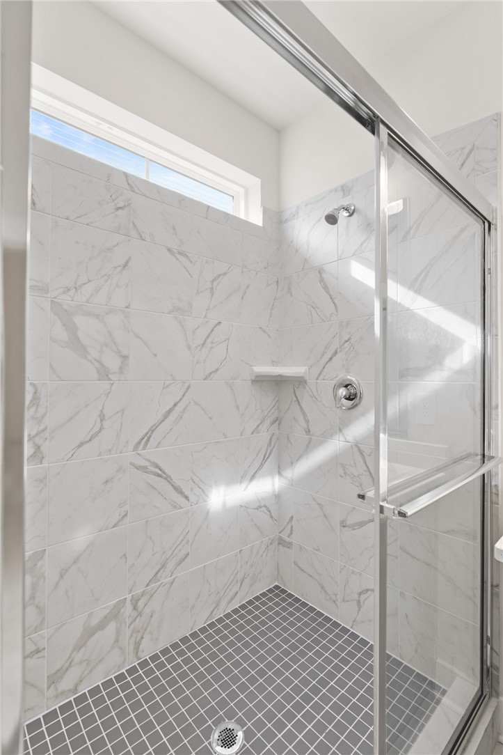 167 Tiger Lily Drive Anderson, SC 29621 - Photo 13 of 34 A well-appointed shower stall features sleek glass enclosure and natural light from a high window.