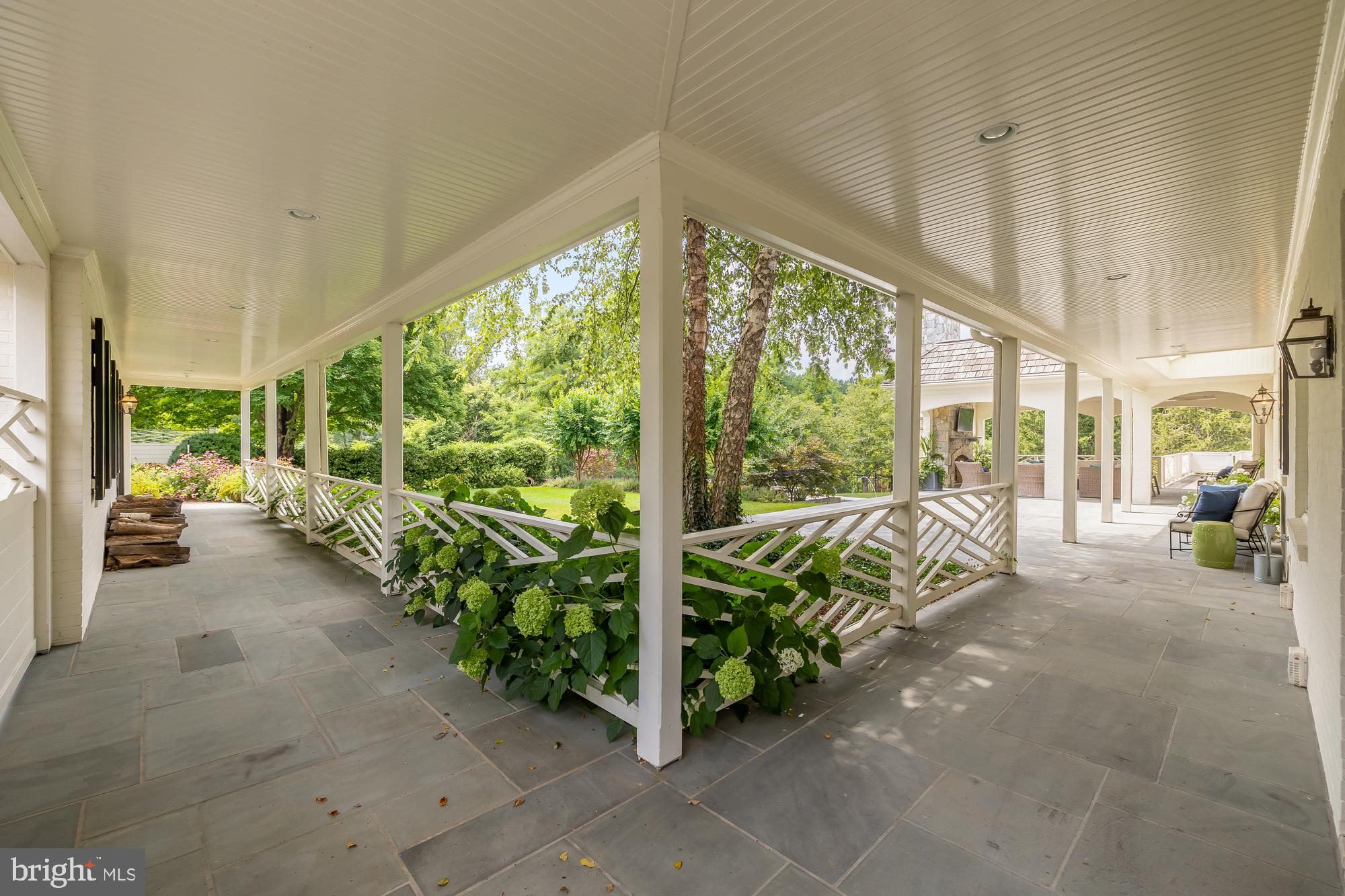 11101 Piney Meetinghouse Road Potomac, MD 20854 - Photo 81 of 96 Serene porch with lush greenery.
