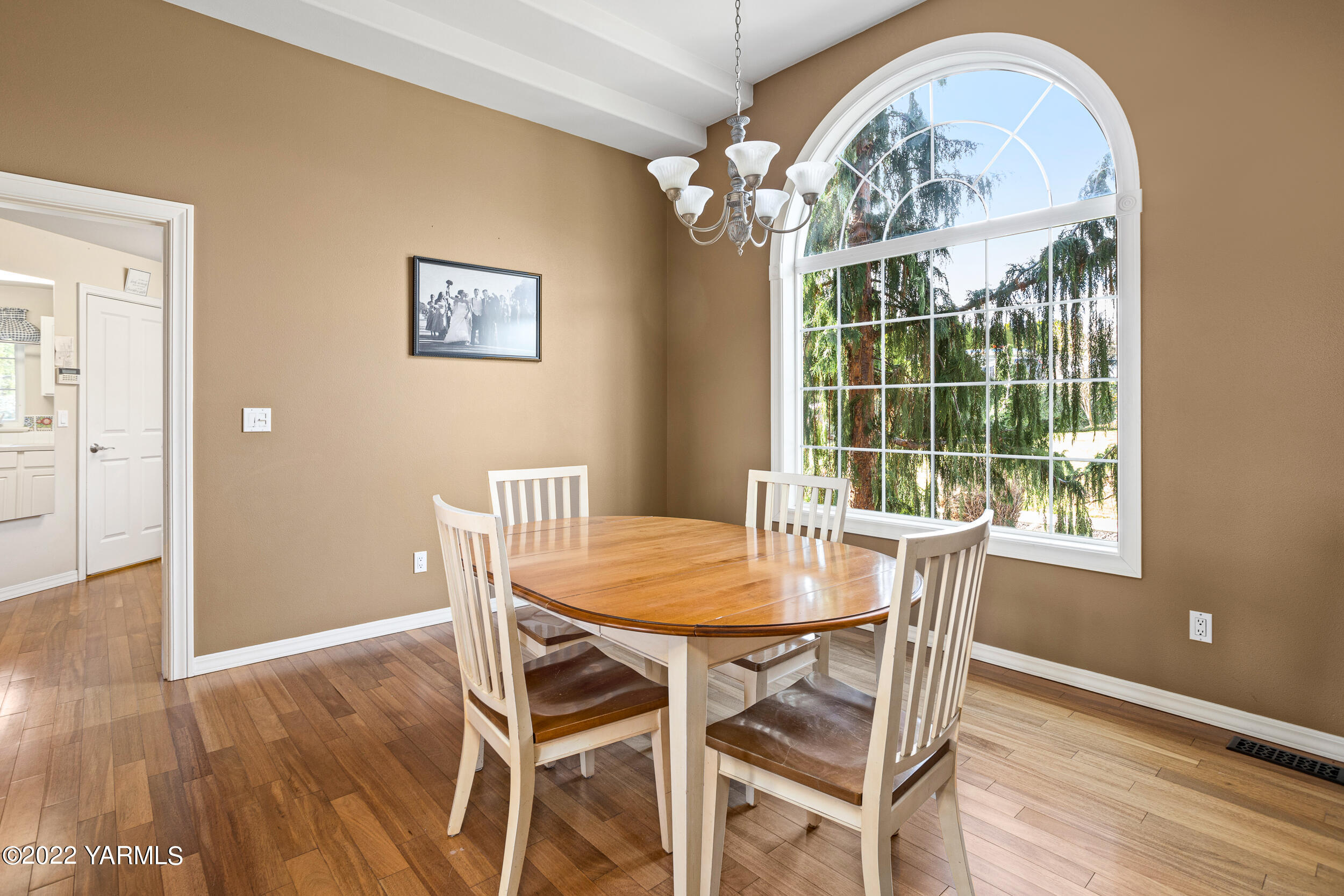 805 South Hennessy Road Yakima, WA 98908 - Photo 9 of 26 a view of a dining room with furniture wooden floor and chandelier