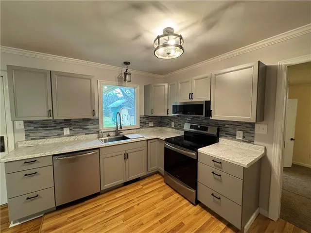 a kitchen with a sink and cabinets