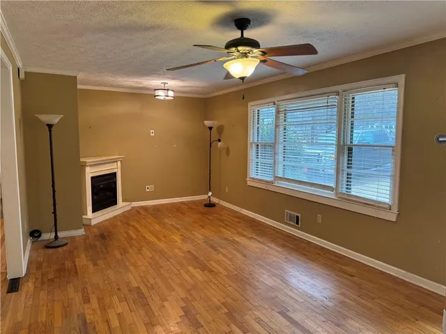 a large kitchen with stainless steel appliances kitchen island granite countertop a stove and a sink