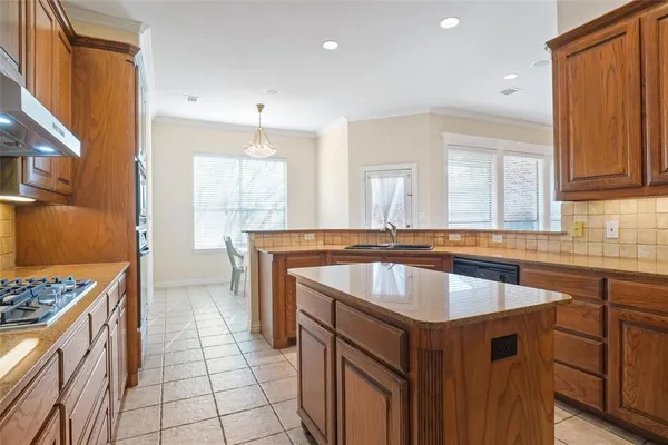 a kitchen with a sink stove and cabinets