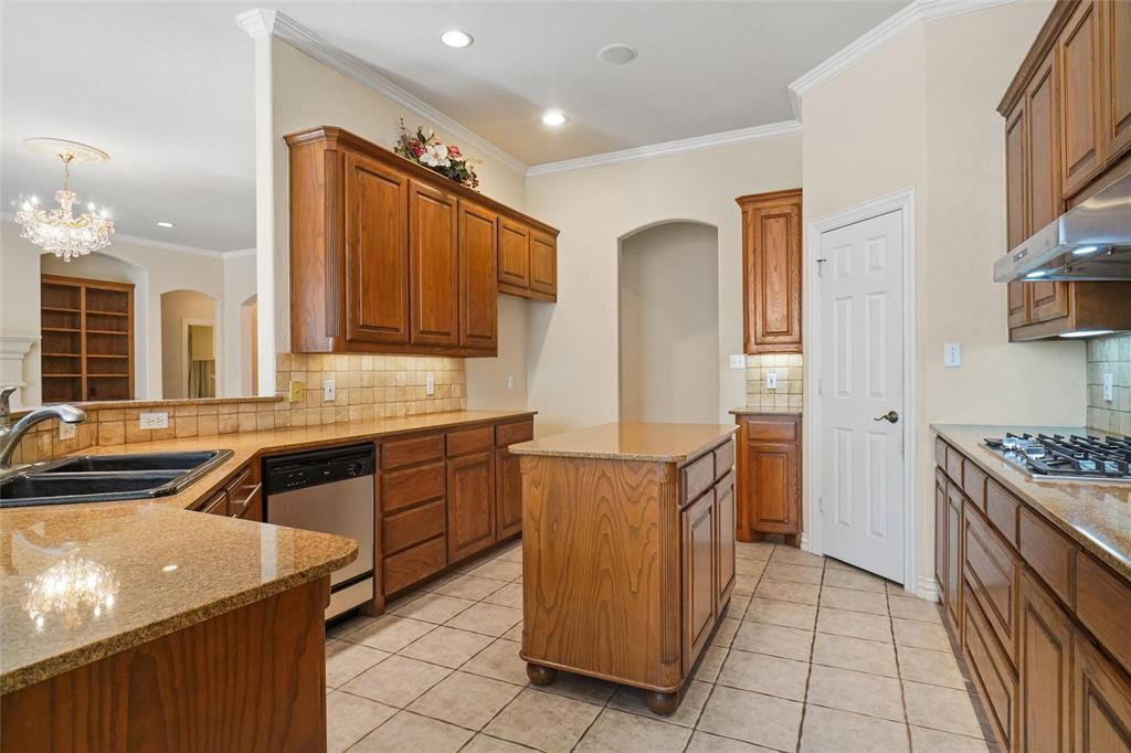 756 Trails End Circle Hurst, TX 76054 - Photo 12 of 26 a kitchen with granite countertop a sink stove and cabinets