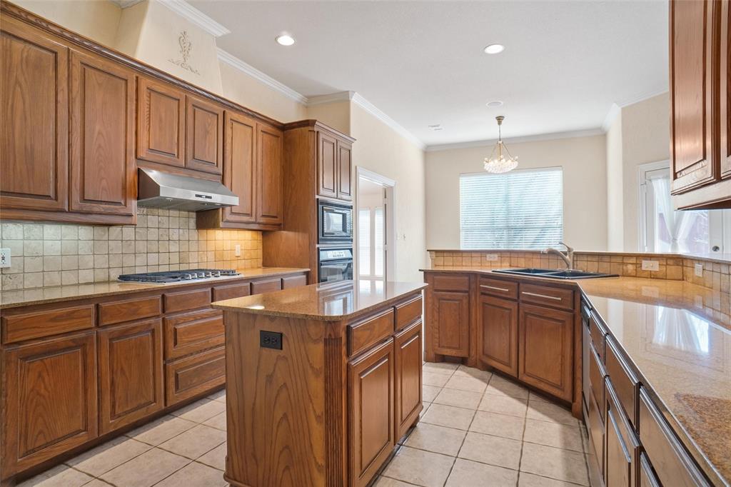 756 Trails End Circle Hurst, TX 76054 - Photo 13 of 26 a kitchen with stainless steel appliances granite countertop wooden cabinets and sink