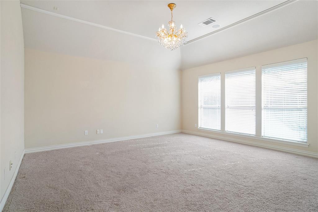 756 Trails End Circle Hurst, TX 76054 - Photo 14 of 26 en empty room with windows and chandelier