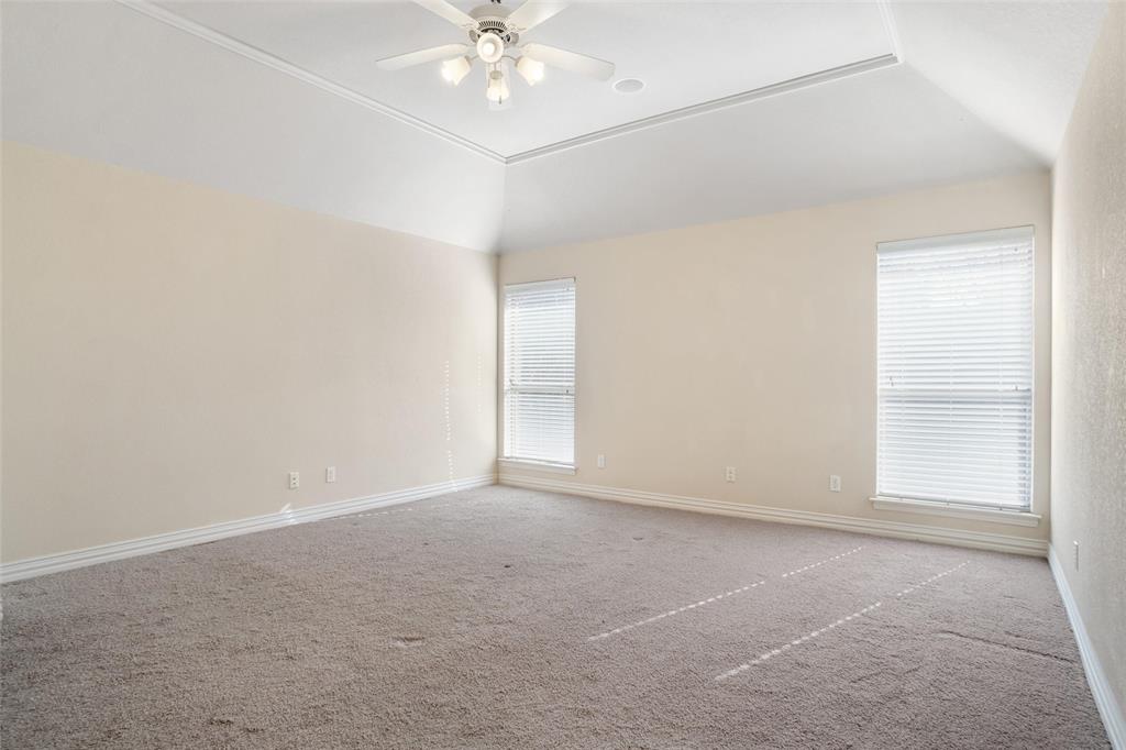 756 Trails End Circle Hurst, TX 76054 - Photo 15 of 26 an empty room with a chandelier fan and windows