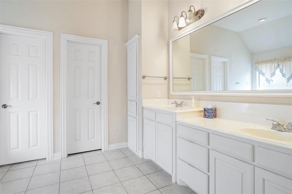 756 Trails End Circle Hurst, TX 76054 - Photo 17 of 26 a bathroom with a sink and a mirror