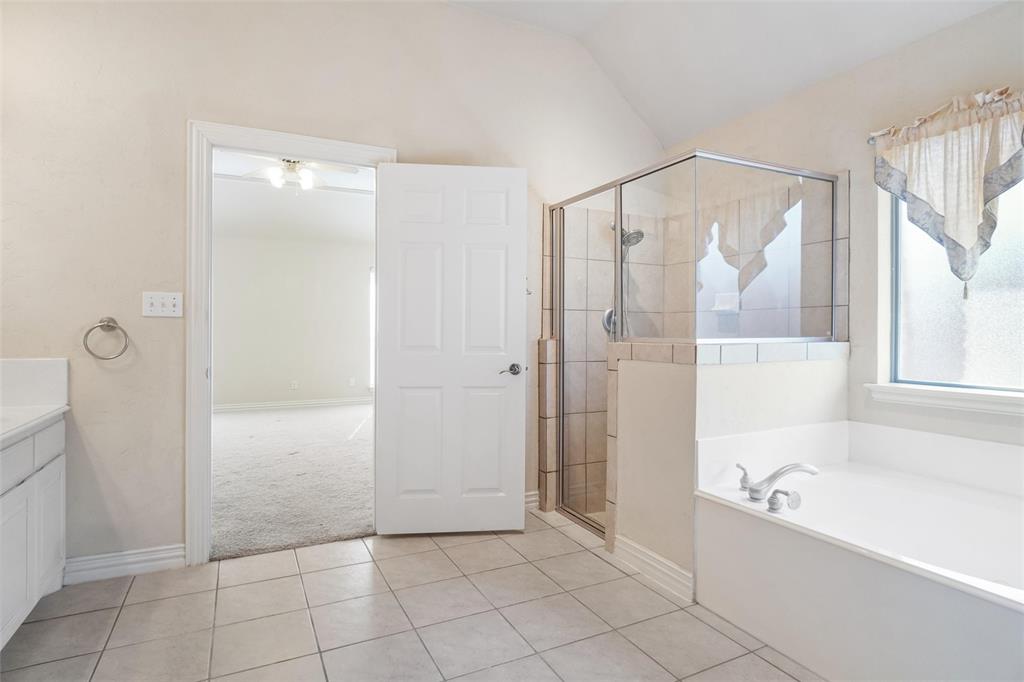 756 Trails End Circle Hurst, TX 76054 - Photo 18 of 26 a bathroom with a bathtub and a shower