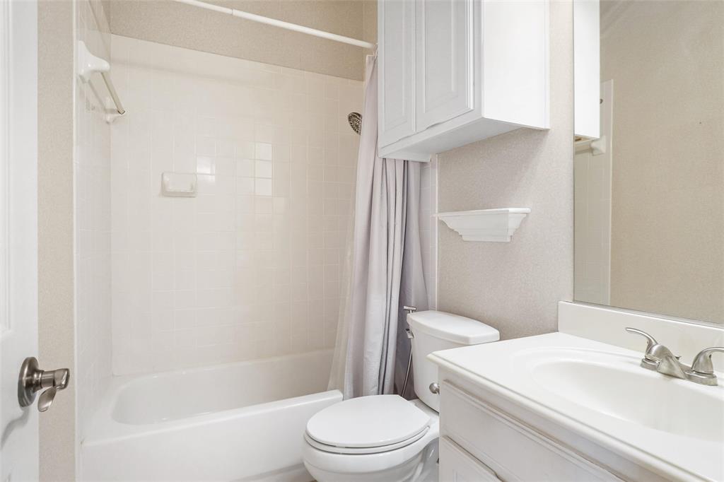 756 Trails End Circle Hurst, TX 76054 - Photo 20 of 26 a white toilet sitting next to a bath tub
